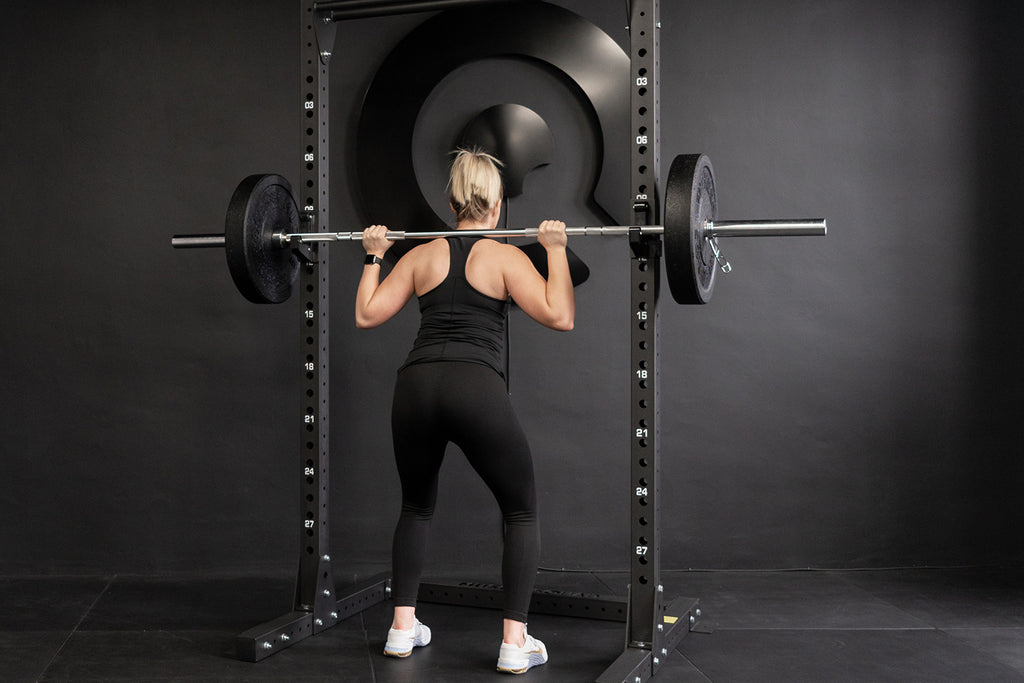 Picture of a women squatting in a home gym studio