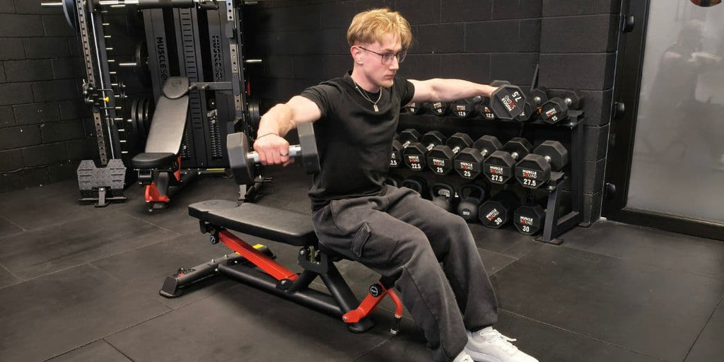 Lateral raises on a weight bench